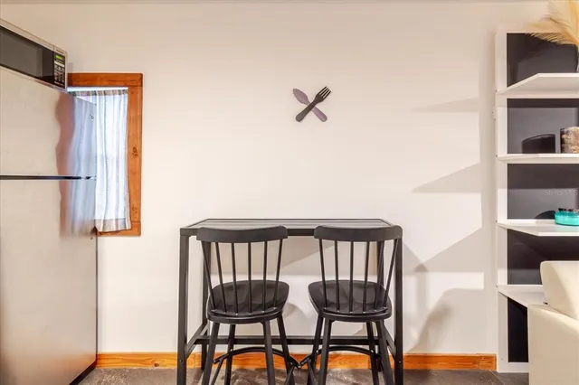 a kitchen with stainless steel appliances kitchen island granite countertop a refrigerator and a sink