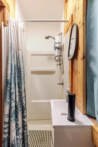a bed sitting in a bedroom next to a window with balcony