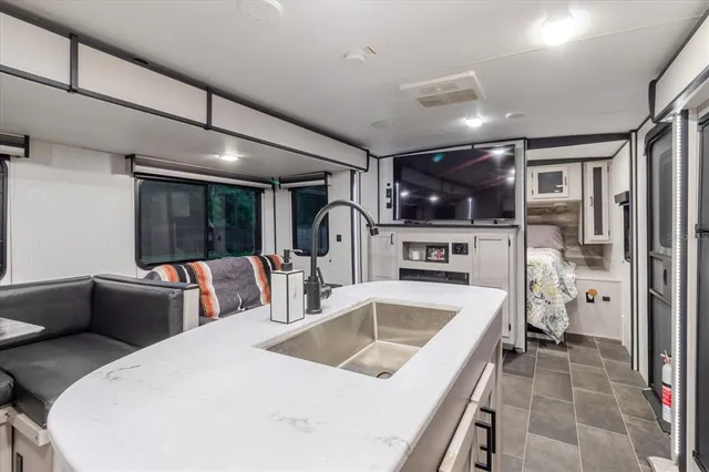a bathroom with a granite countertop sink and a mirror