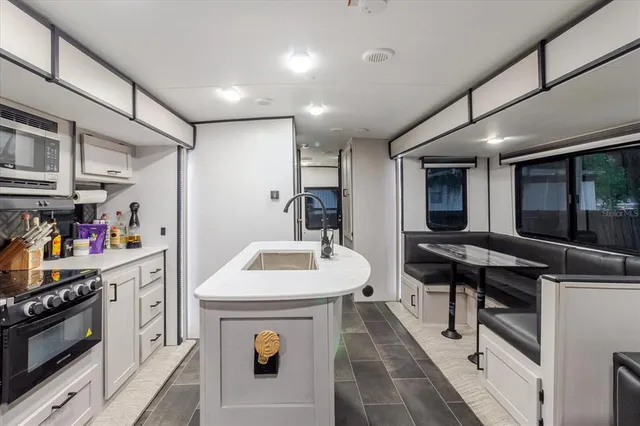 a bathroom with a granite countertop sink a mirror and shower