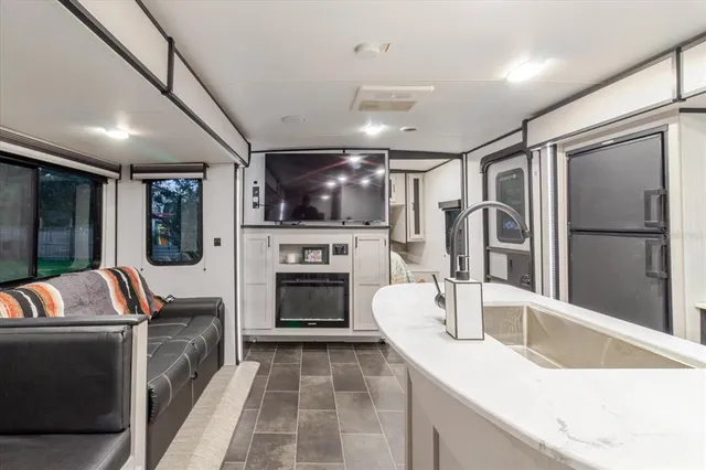 a view of a roof deck with table and chairs and wooden floor