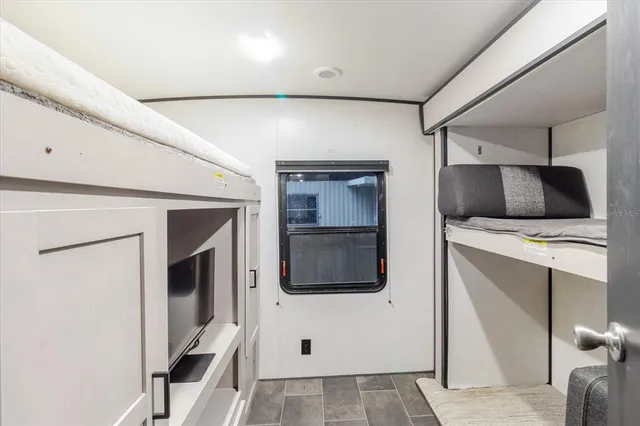 a view of swimming pool with lawn chairs and plants