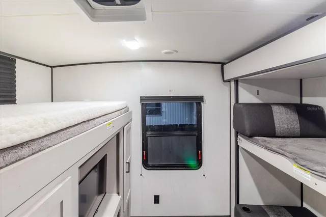 a view of house with swimming pool outdoor seating and trees