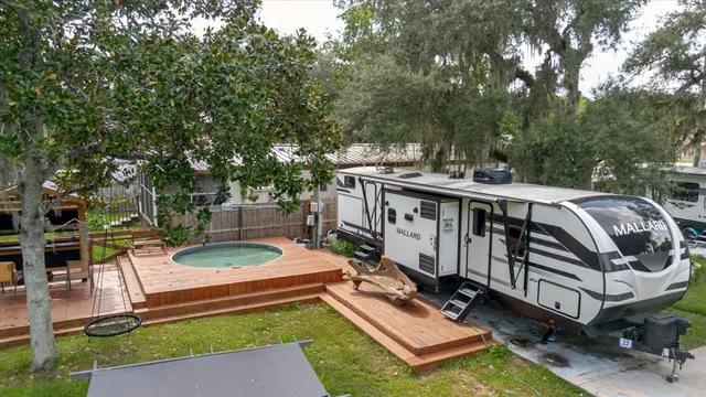 a view of a house with pool and sitting area