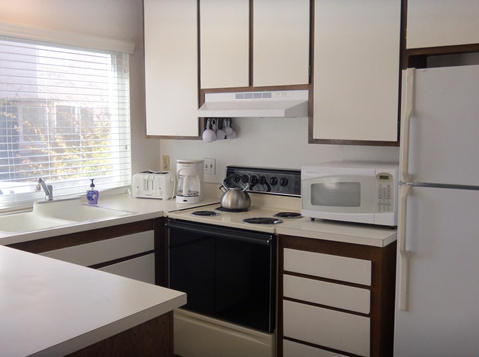 4700 Sandyland Road, Unit 58 Carpinteria, CA 93013 - Photo 3 of 12 a kitchen with stainless steel appliances granite countertop a sink stove and refrigerator