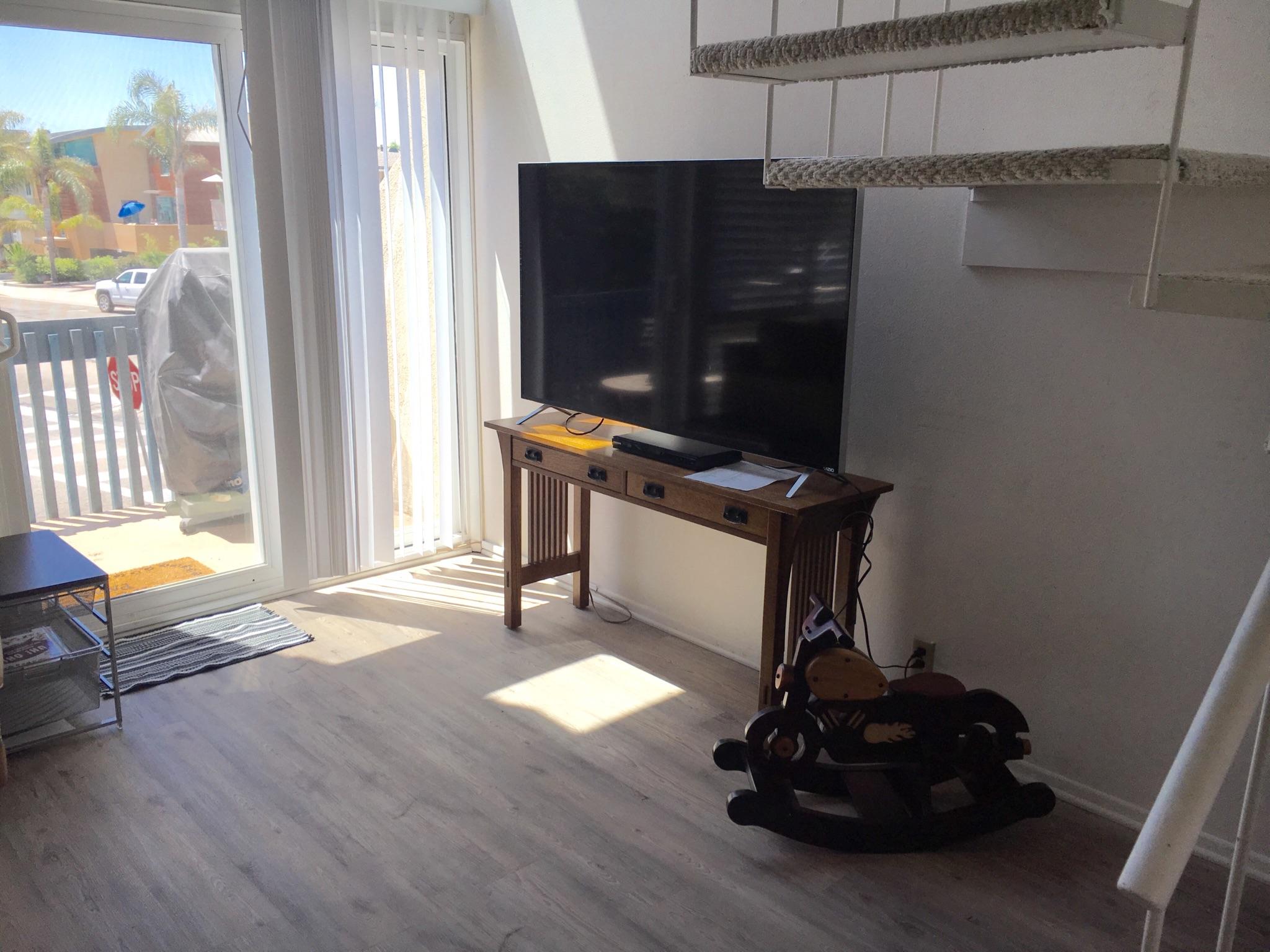 4700 Sandyland Road, Unit 58 Carpinteria, CA 93013 - Photo 4 of 12 a living room with furniture a flat screen tv and a window