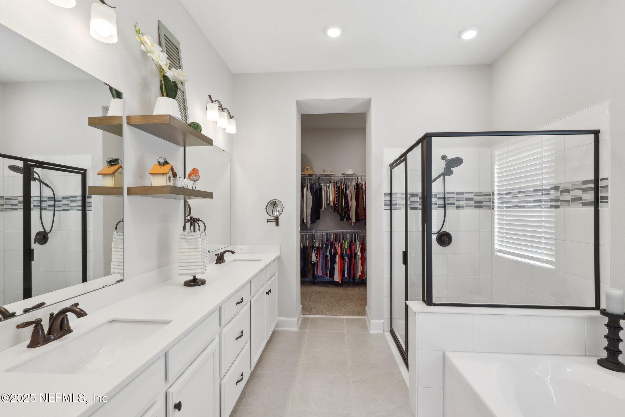 406 Navigators Road St. Johns, FL 32259 - Photo 11 of 57 a bathroom with a double vanity sink a mirror and shower