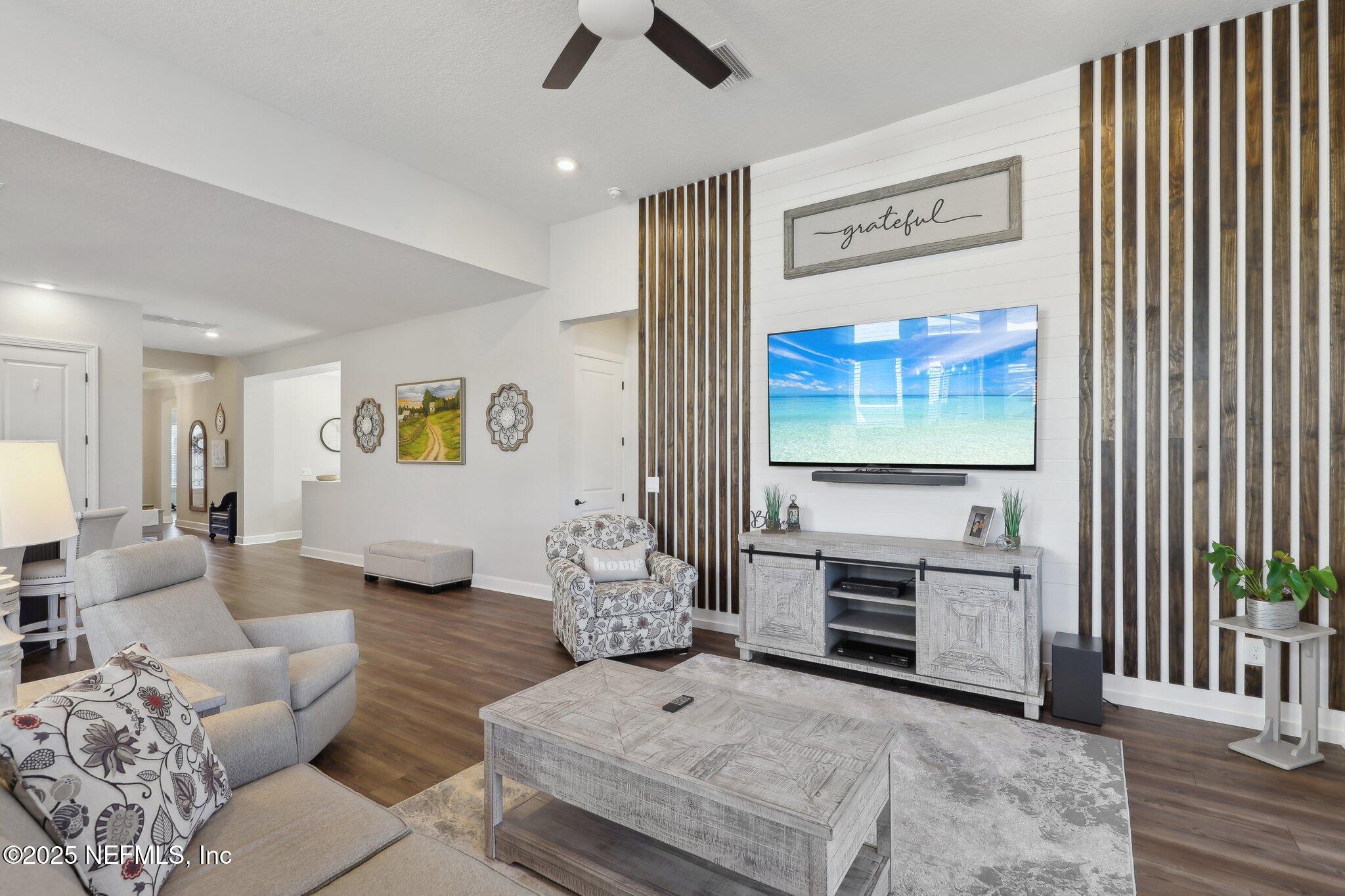 406 Navigators Road St. Johns, FL 32259 - Photo 19 of 57 a living room with furniture and a flat screen tv