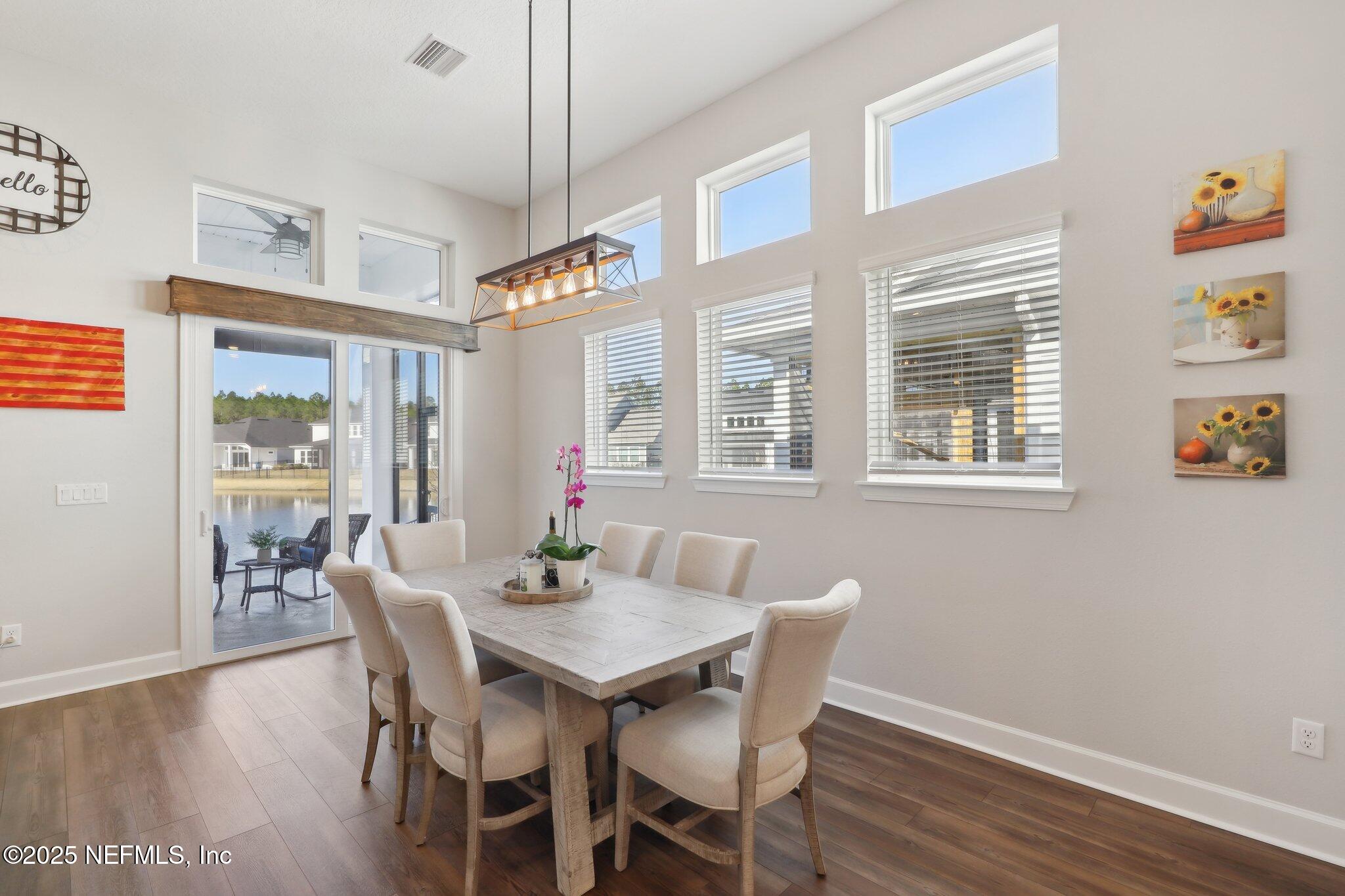 406 Navigators Road St. Johns, FL 32259 - Photo 20 of 57 a view of a dining room with furniture window and wooden floor