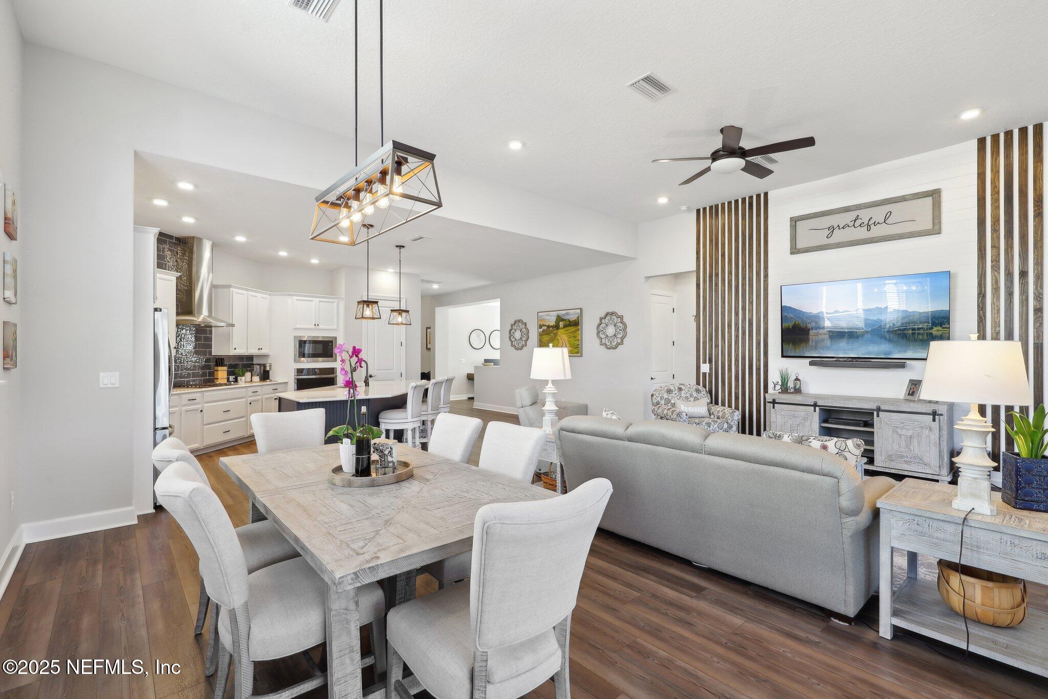 406 Navigators Road St. Johns, FL 32259 - Photo 22 of 57 a view of a dining room with furniture and wooden floor