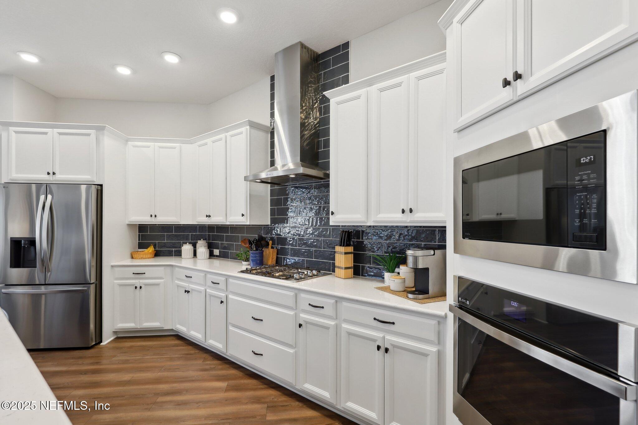 406 Navigators Road St. Johns, FL 32259 - Photo 25 of 57 a kitchen with a sink stainless steel appliances and white cabinets