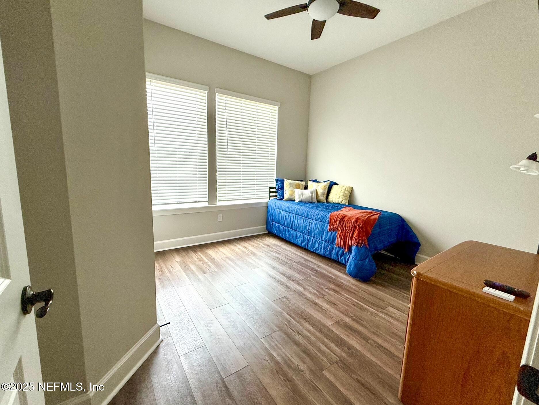 406 Navigators Road St. Johns, FL 32259 - Photo 28 of 57 a bedroom with two beds and a chandelier