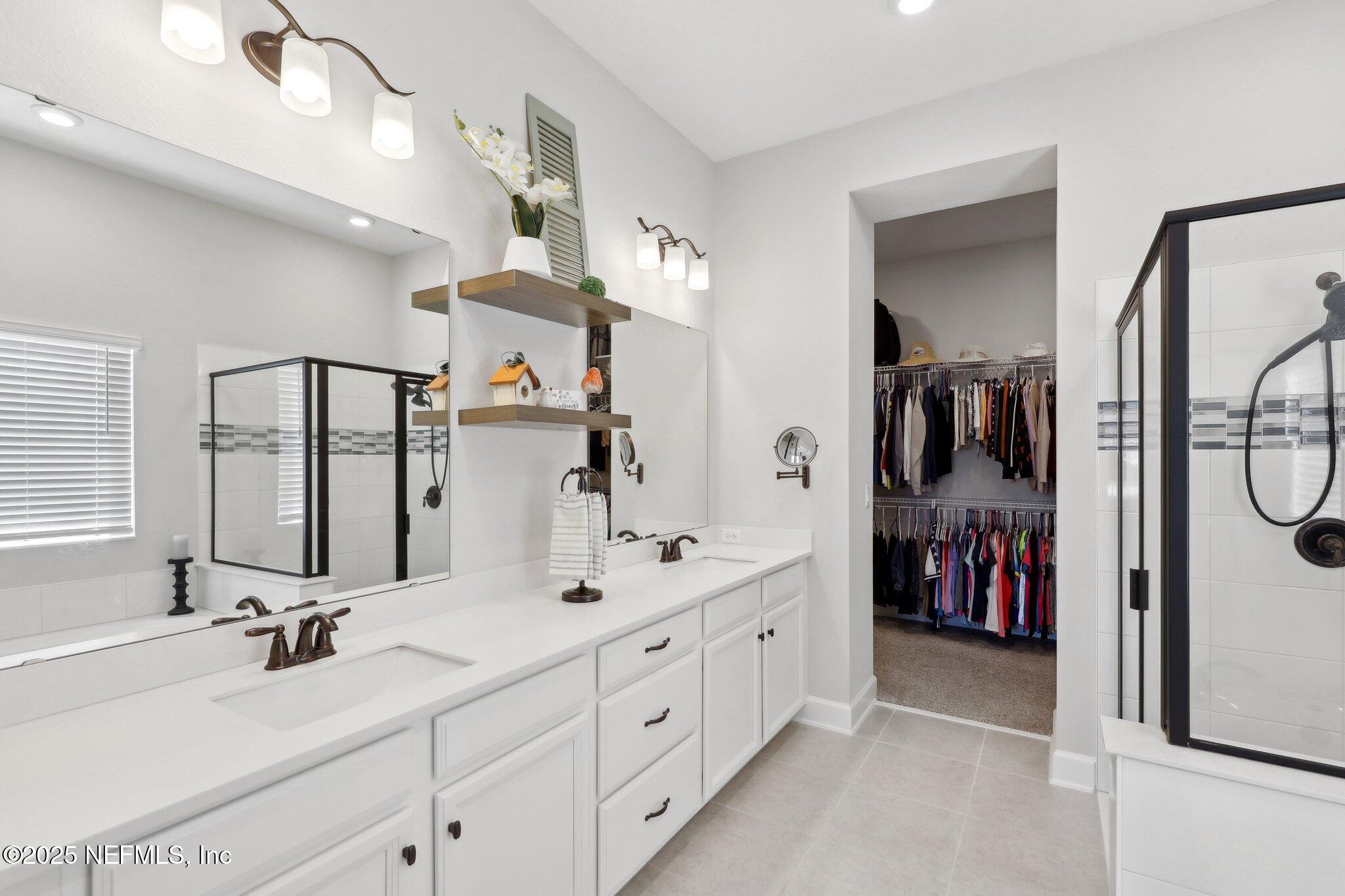 406 Navigators Road St. Johns, FL 32259 - Photo 40 of 57 a bathroom with a double vanity sink and a mirror