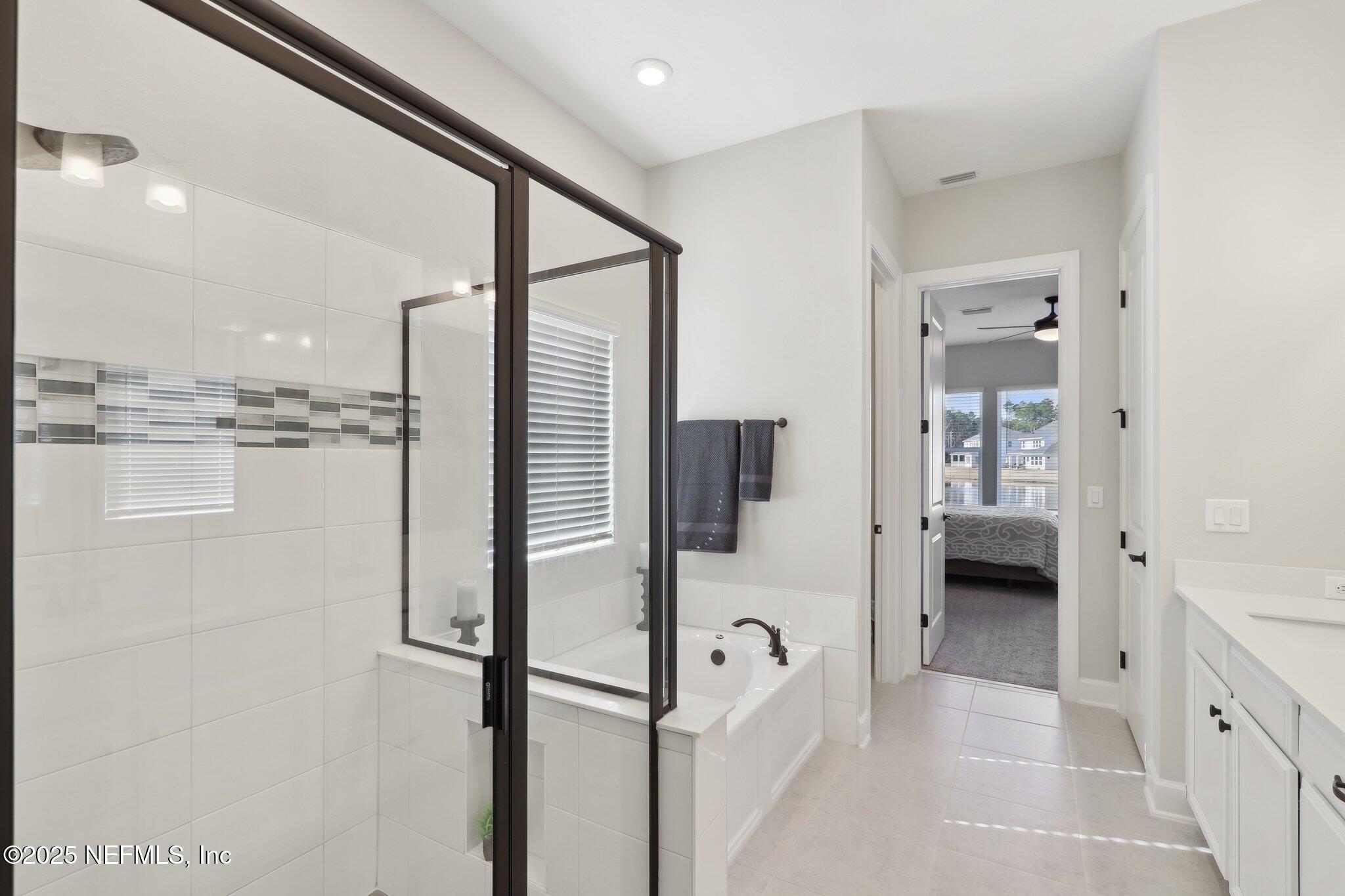 406 Navigators Road St. Johns, FL 32259 - Photo 41 of 57 a en suite bathroom with a shower and mirror