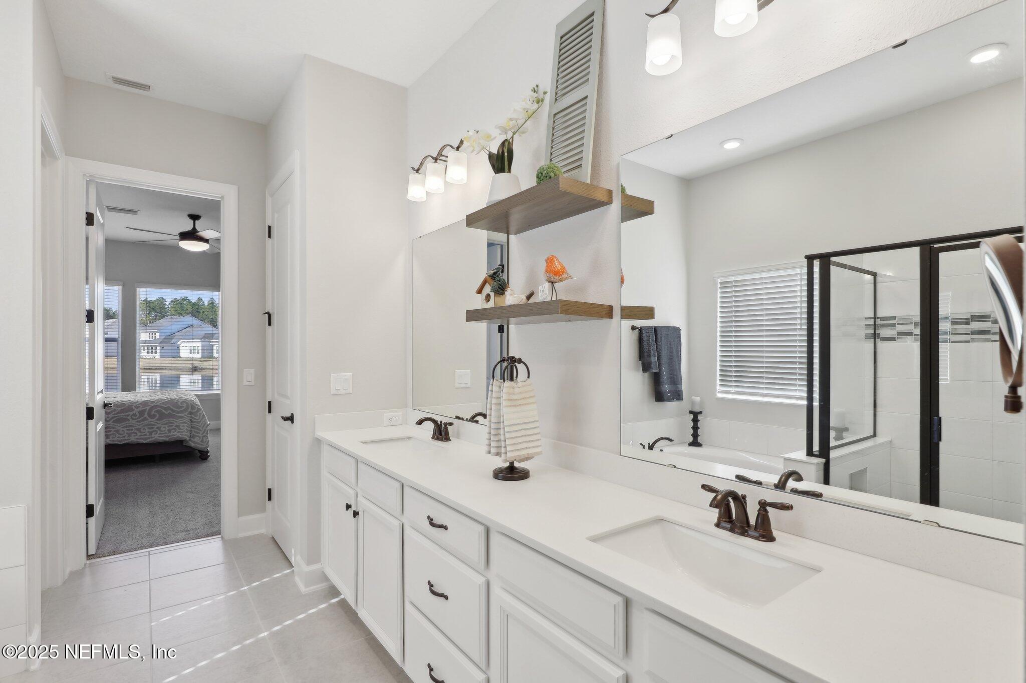 406 Navigators Road St. Johns, FL 32259 - Photo 42 of 57 a bathroom with double vanity sink a mirror and shower