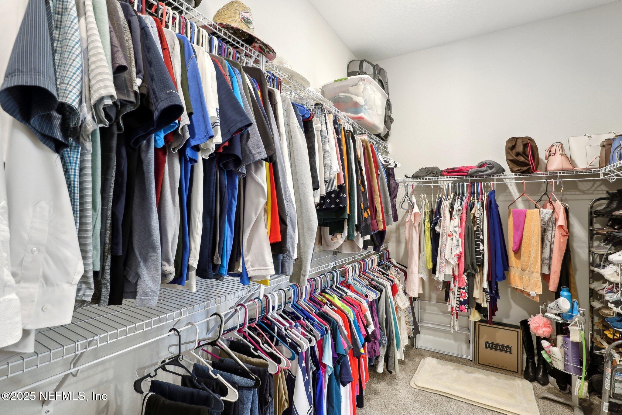 406 Navigators Road St. Johns, FL 32259 - Photo 43 of 57 a view of walk in closet with clothes