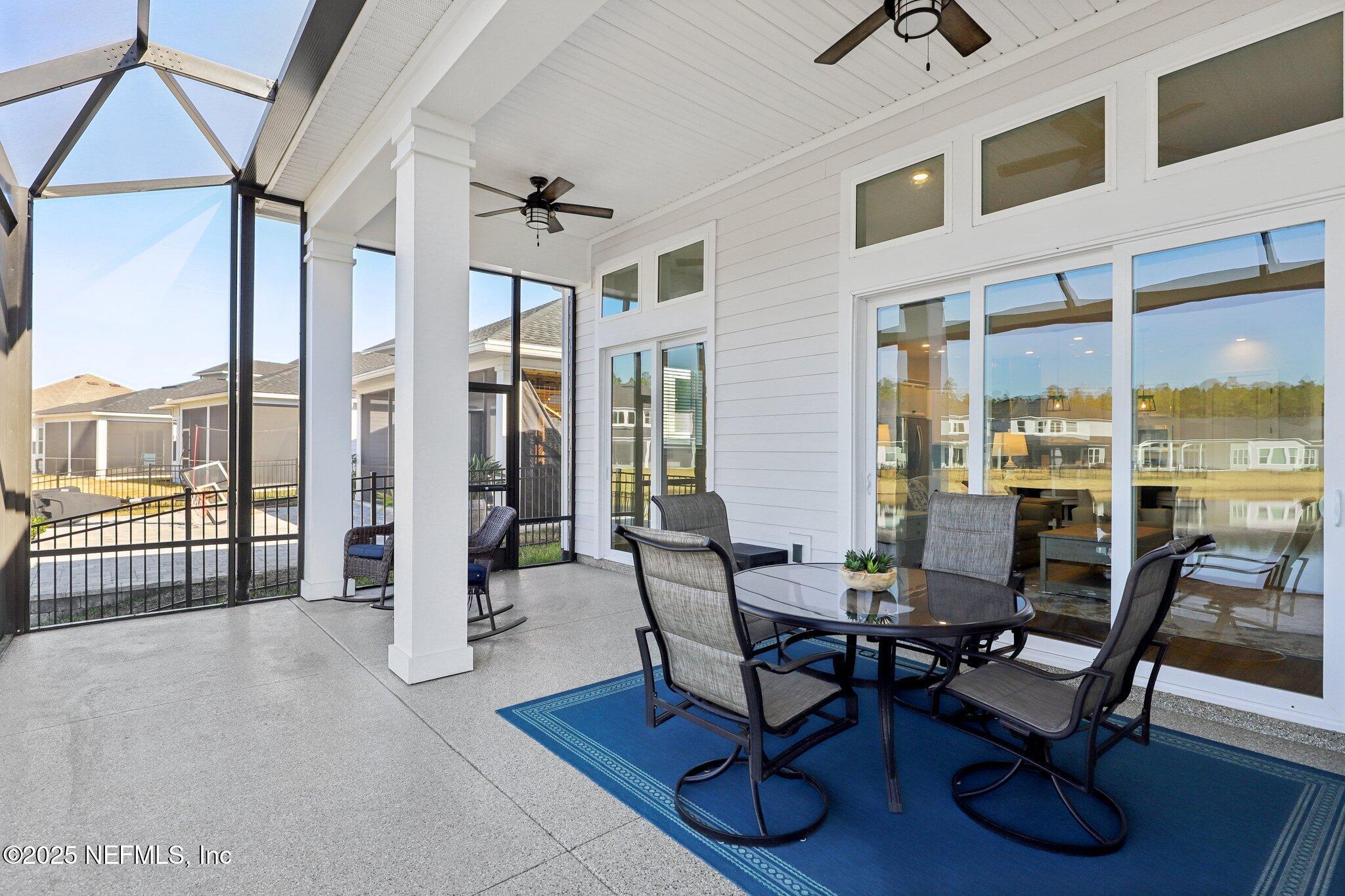 406 Navigators Road St. Johns, FL 32259 - Photo 44 of 57 a dining room with furniture water view and a floor to ceiling window