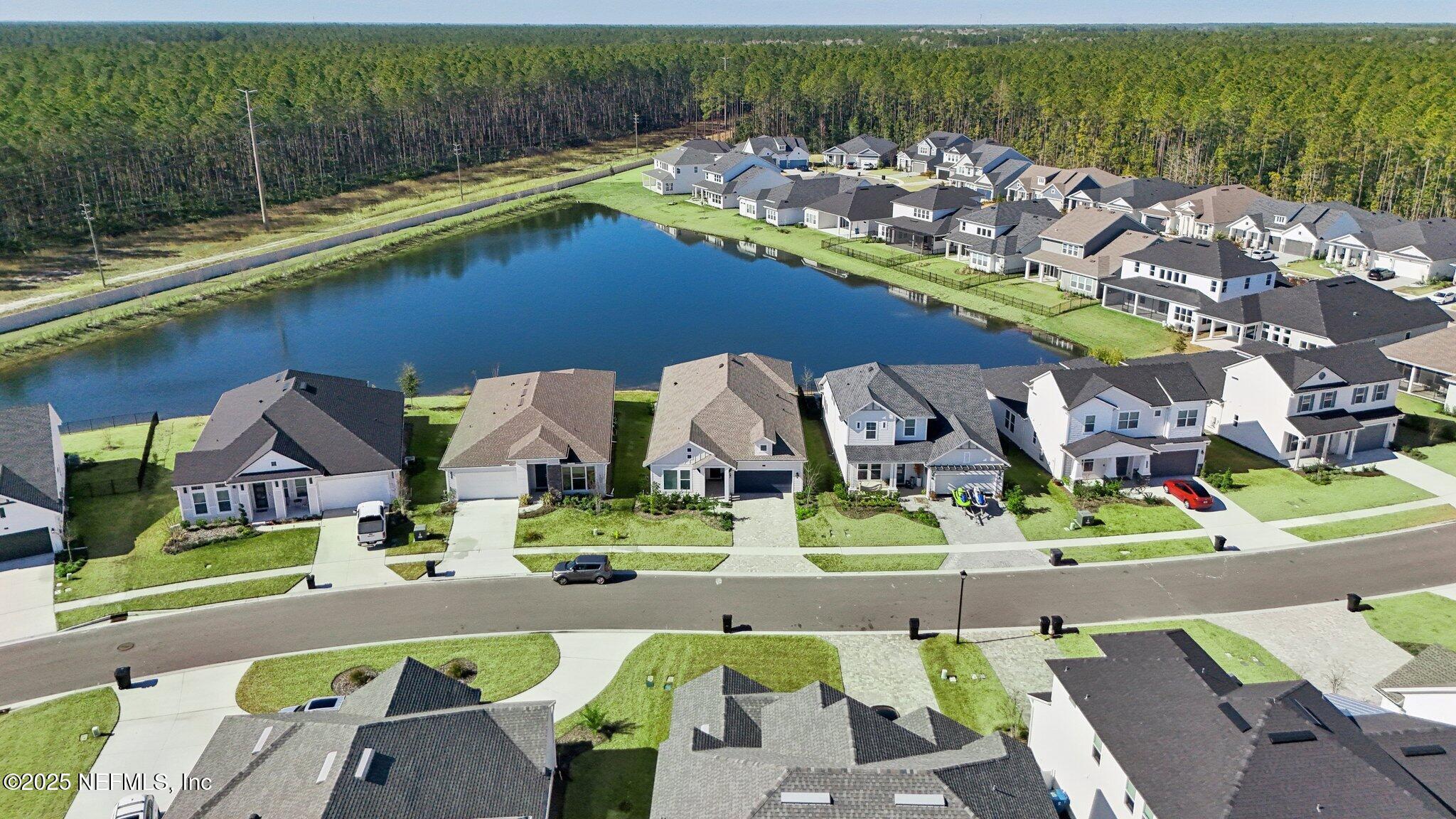 406 Navigators Road St. Johns, FL 32259 - Photo 50 of 57 an aerial view of a house with a swimming pool patio and outdoor seating
