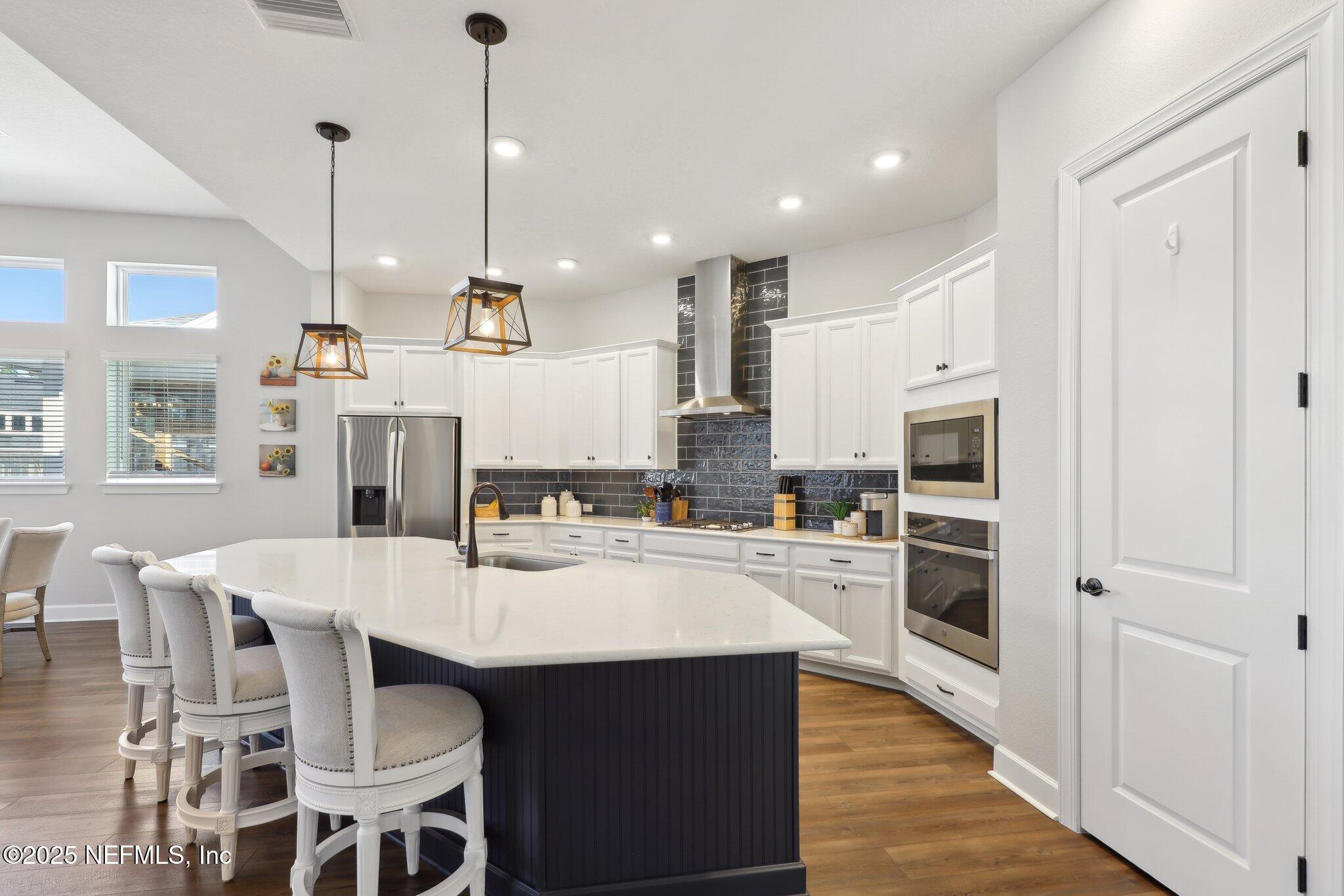 406 Navigators Road St. Johns, FL 32259 - Photo 6 of 57 a kitchen with refrigerator cabinets dining table and chairs