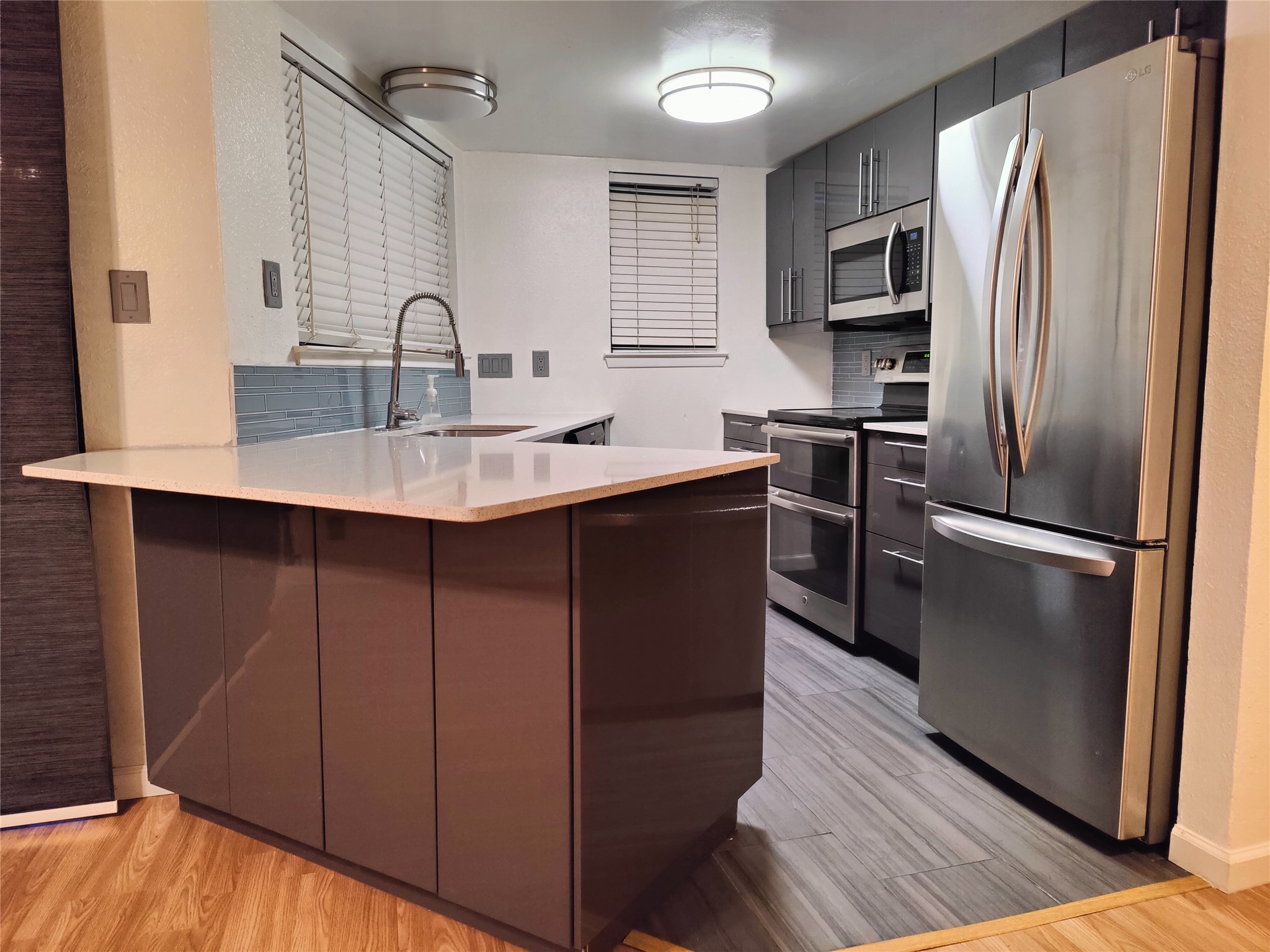 a kitchen with kitchen island a sink appliances and cabinets