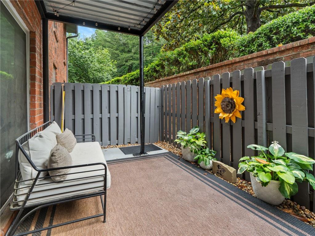 6851 Roswell Road, Unit H26 Atlanta, GA 30328 - Photo 29 of 49 a backyard of a house with a garden and outdoor seating