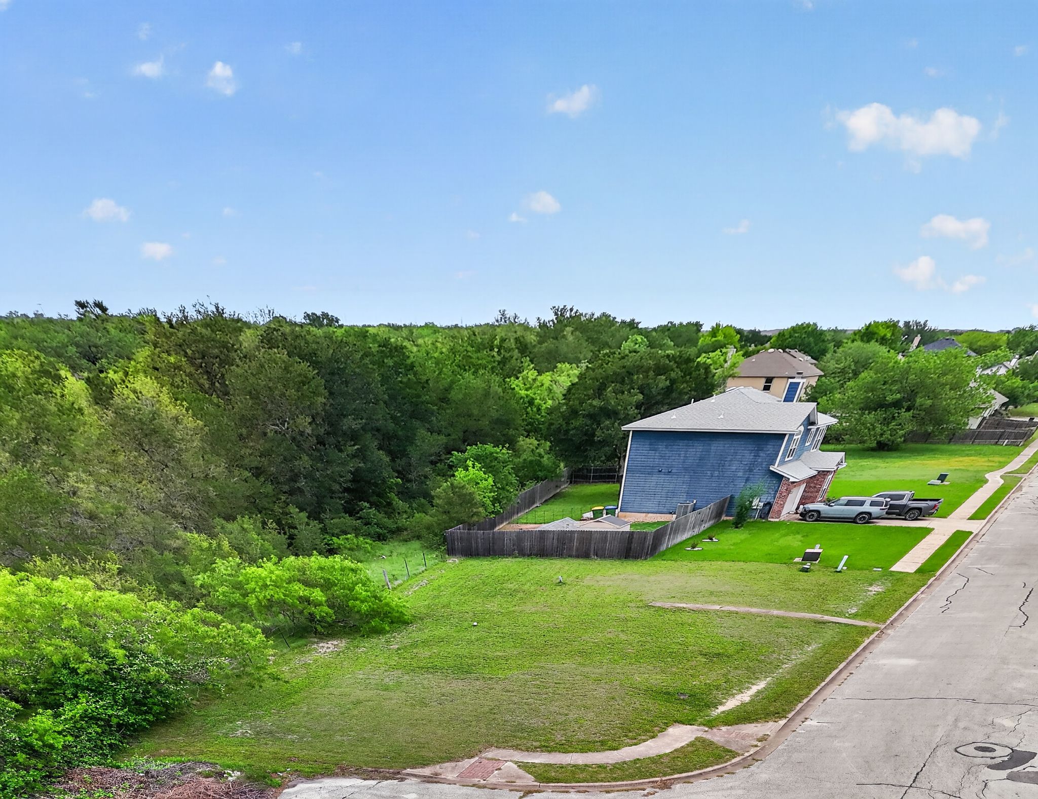 11908 Athens Street Manor, TX 78653 - Photo 6 of 15 a view of a house with a backyard and a garden
