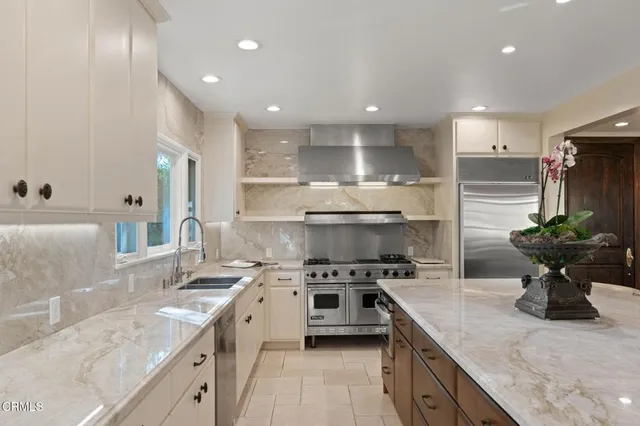 a kitchen with a sink stainless steel appliances and cabinets