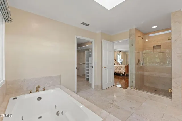 a bathroom with a bathtub and a shower