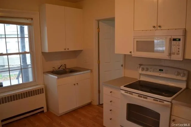 a kitchen with a stove microwave and sink