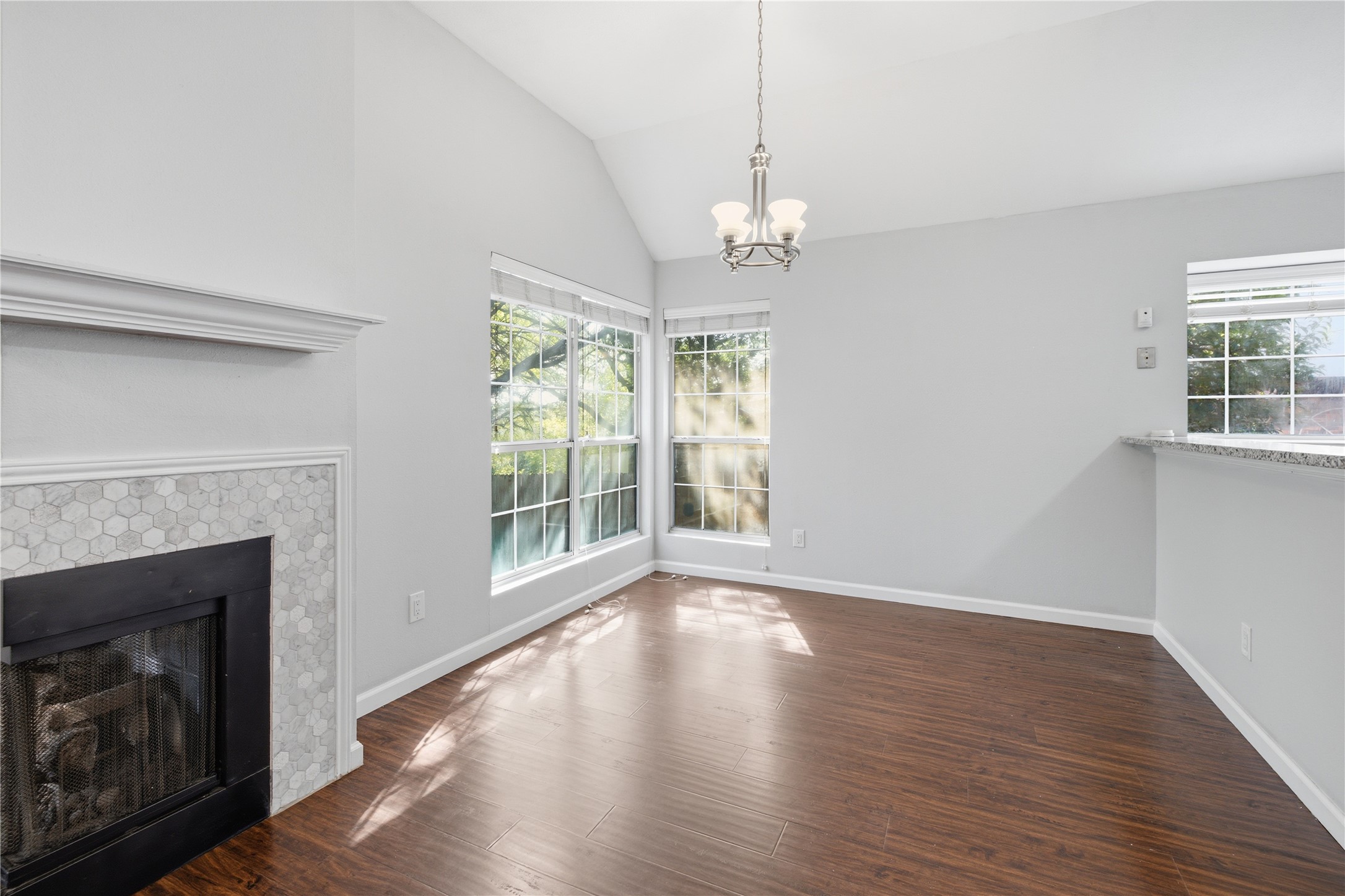 2922 Wickersham Lane Austin, TX 78741 - Photo 8 of 26 a view of a livingroom with wooden floor a fireplace and windows