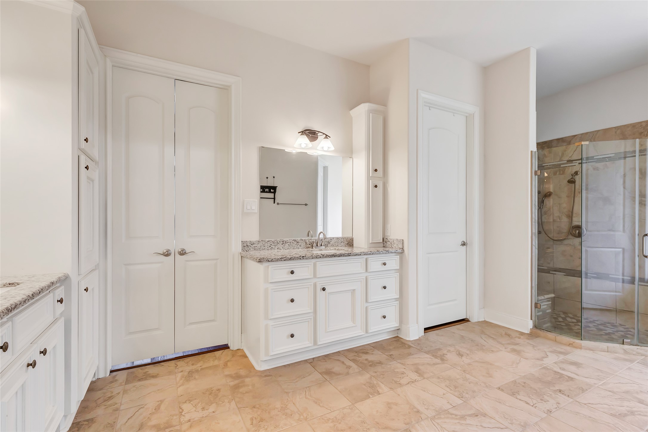 229 Sundog Road Huntsville, TX 77340 - Photo 43 of 50 One vanity and shower with closed doors to Primary Bedroom