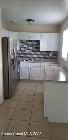 a kitchen with stainless steel appliances granite countertop a sink and cabinets