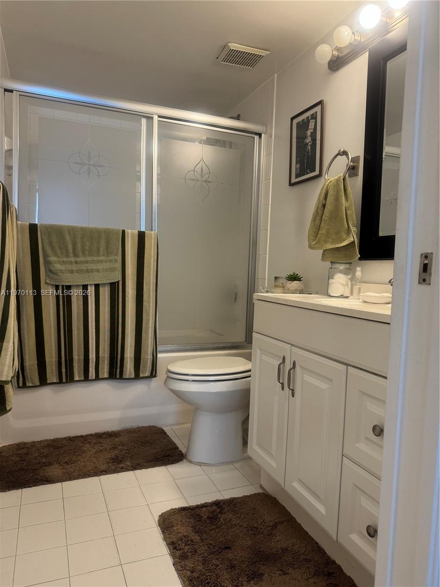 2091 Renaissance Boulevard, Unit 104 Miramar, FL 33025 - Photo 16 of 31 a bathroom with a toilet sink and mirror