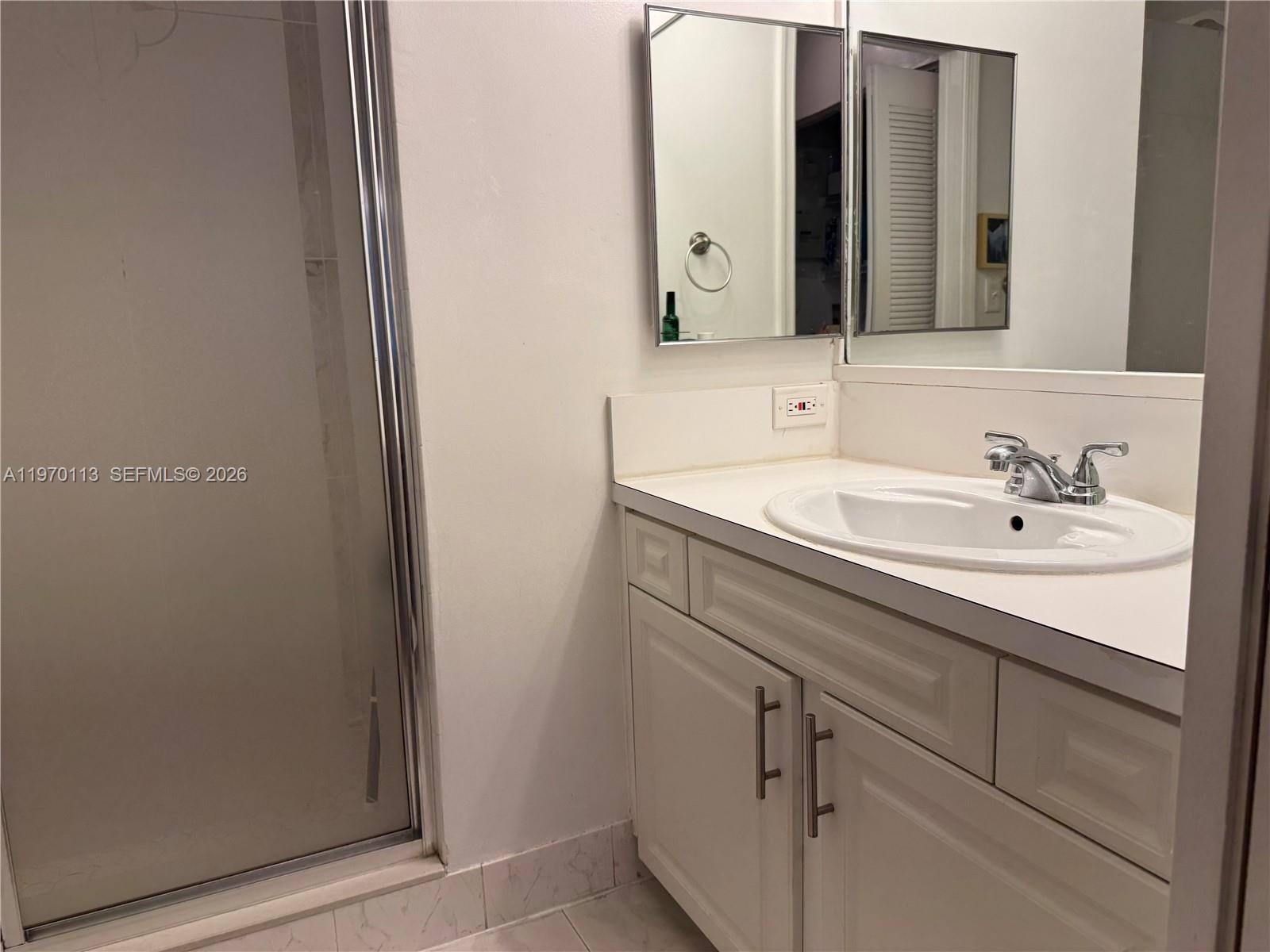 2091 Renaissance Boulevard, Unit 104 Miramar, FL 33025 - Photo 18 of 31 a bathroom with a sink and a mirror