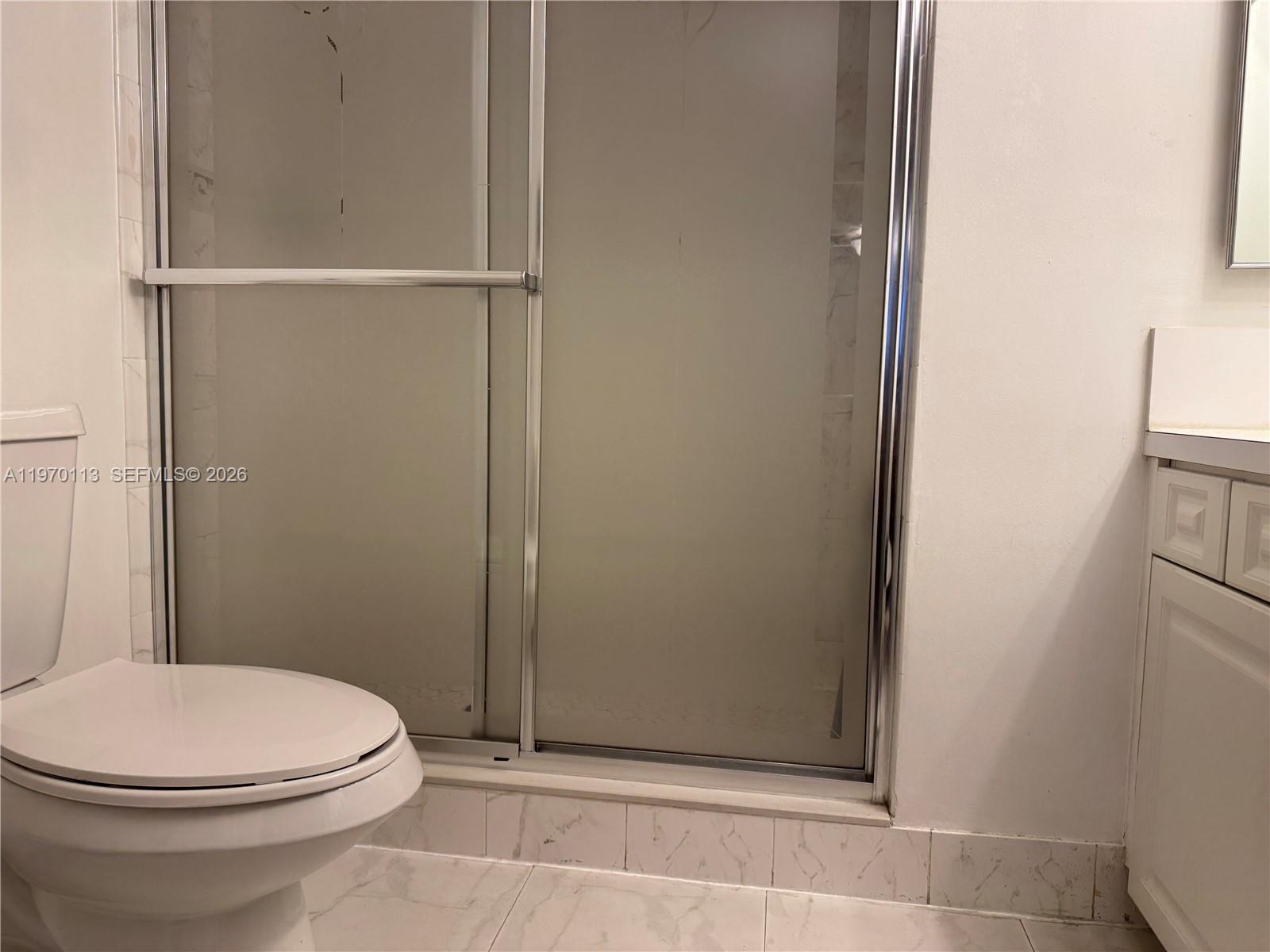 2091 Renaissance Boulevard, Unit 104 Miramar, FL 33025 - Photo 19 of 31 a bathroom with a toilet and a shower