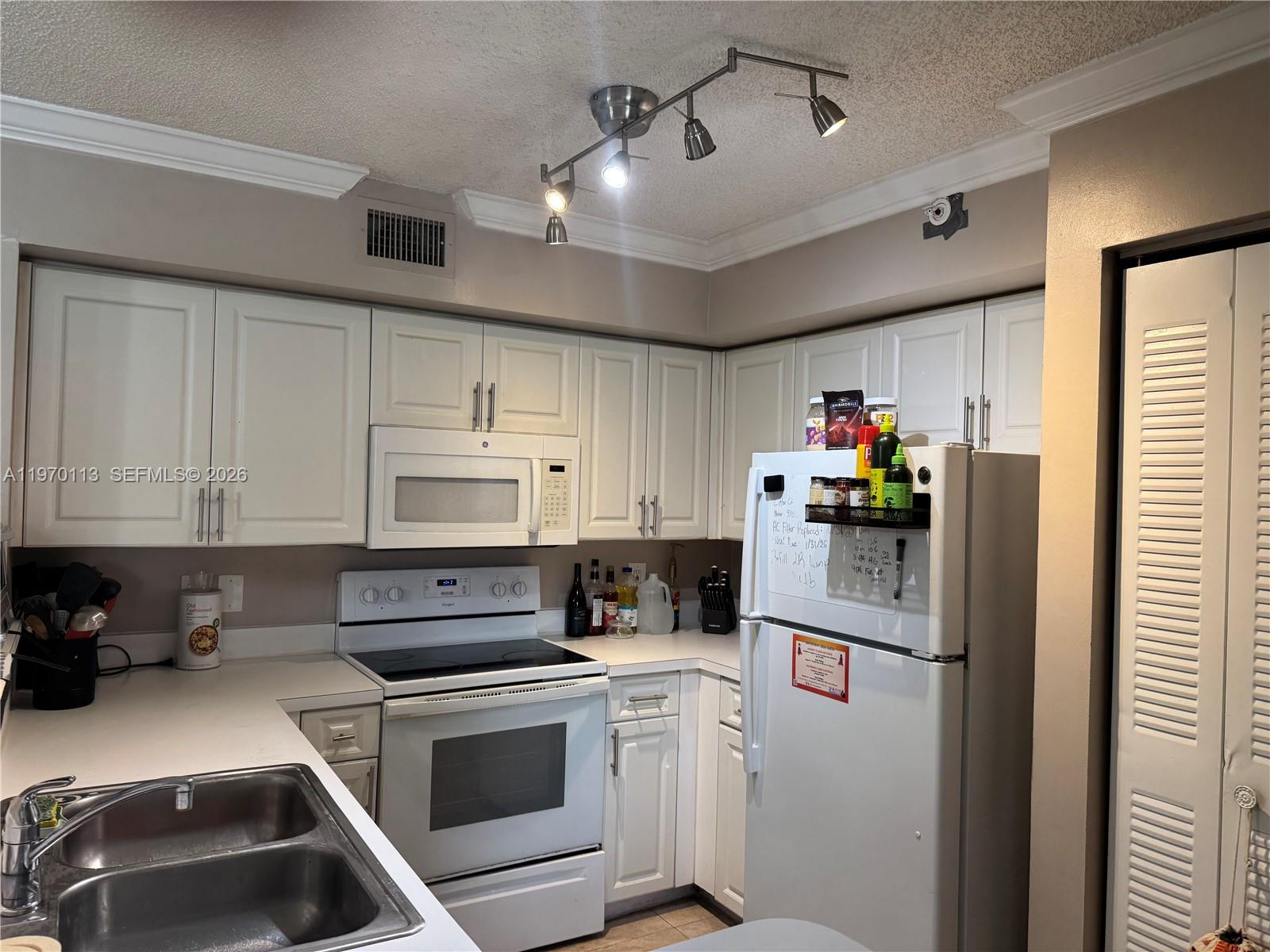 2091 Renaissance Boulevard, Unit 104 Miramar, FL 33025 - Photo 20 of 31 a kitchen with a sink cabinets and stainless steel appliances