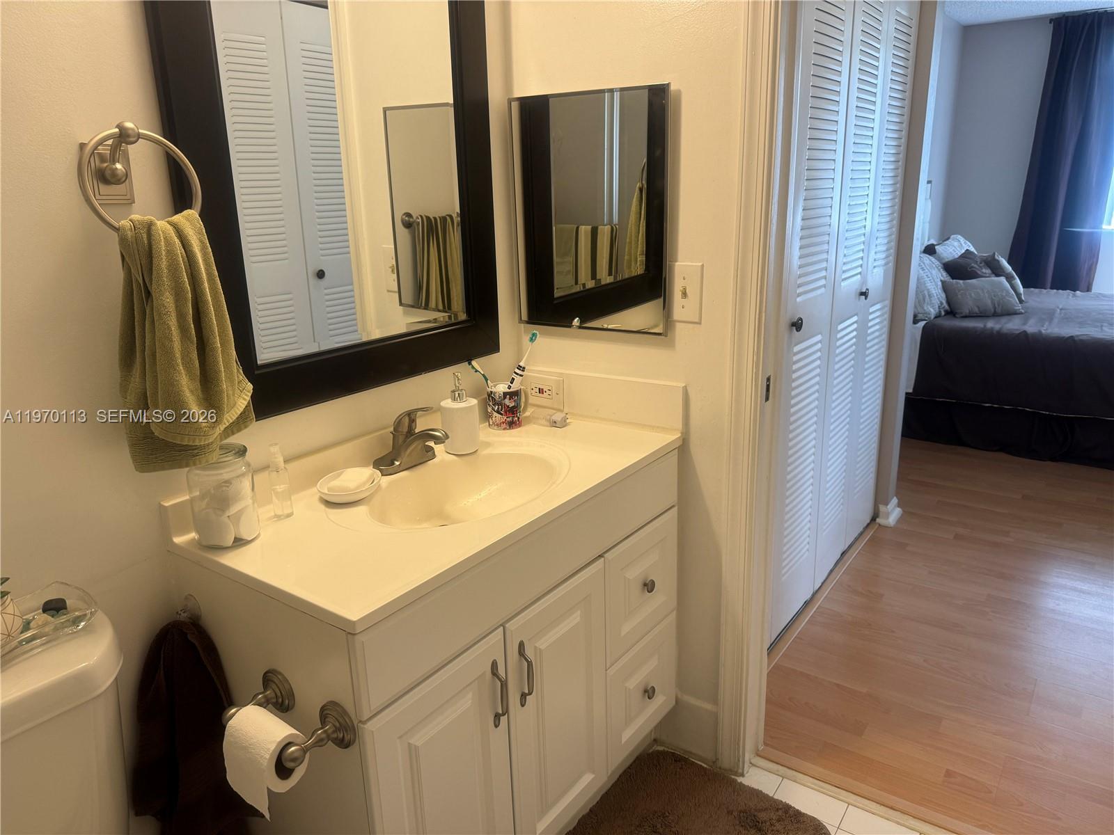 2091 Renaissance Boulevard, Unit 104 Miramar, FL 33025 - Photo 21 of 31 a bathroom with a sink vanity and a mirror