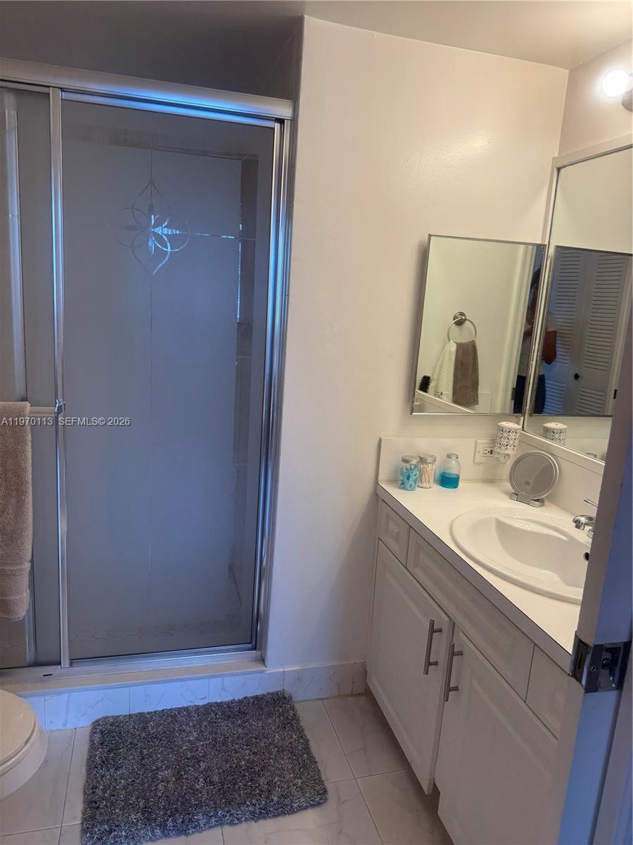 2091 Renaissance Boulevard, Unit 104 Miramar, FL 33025 - Photo 29 of 31 a bathroom with a sink and a mirror