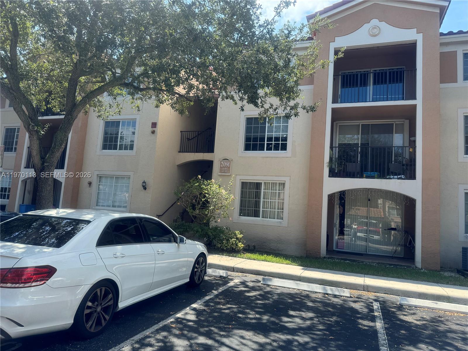 2091 Renaissance Boulevard, Unit 104 Miramar, FL 33025 - Photo 5 of 31 a car parked in front of a house