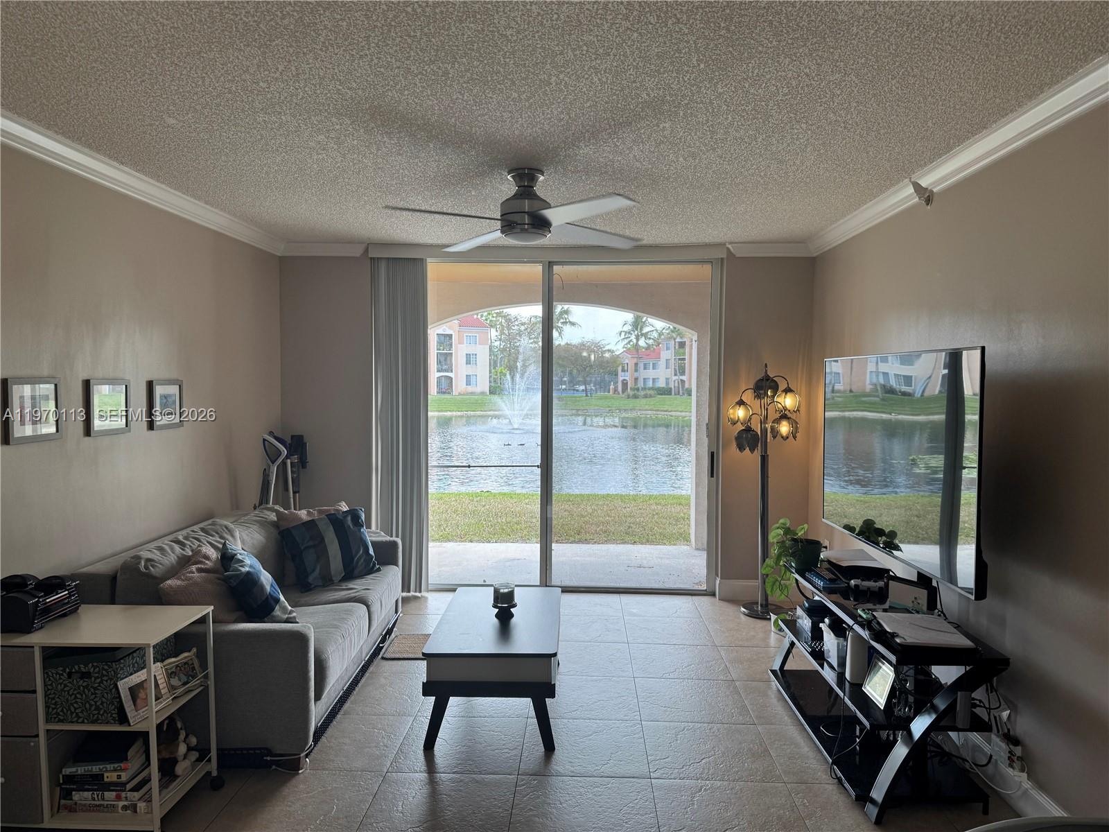 2091 Renaissance Boulevard, Unit 104 Miramar, FL 33025 - Photo 7 of 31 a living room with furniture and a flat screen tv