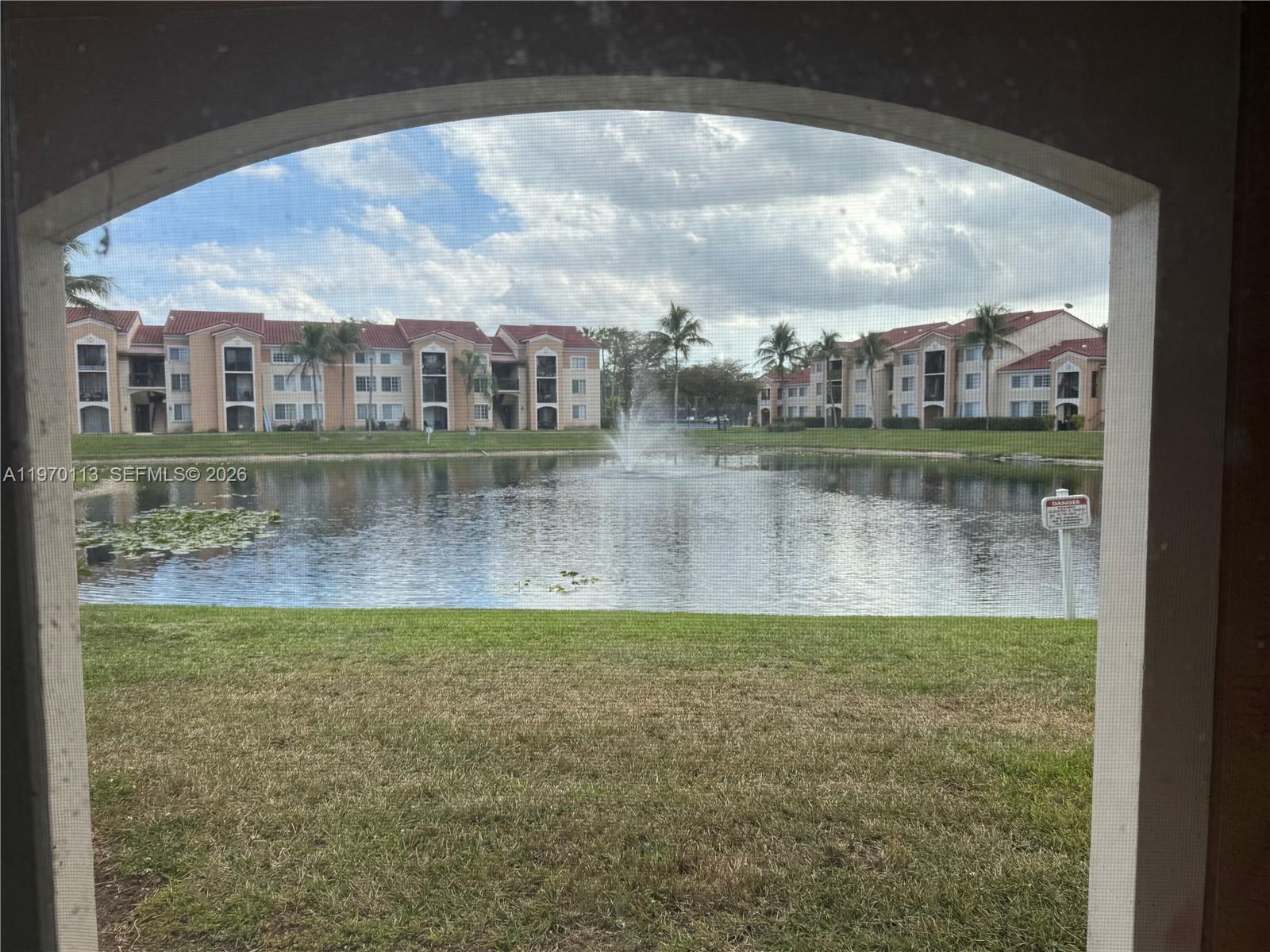 2091 Renaissance Boulevard, Unit 104 Miramar, FL 33025 - Photo 9 of 31 a view of a lake with a building in the background