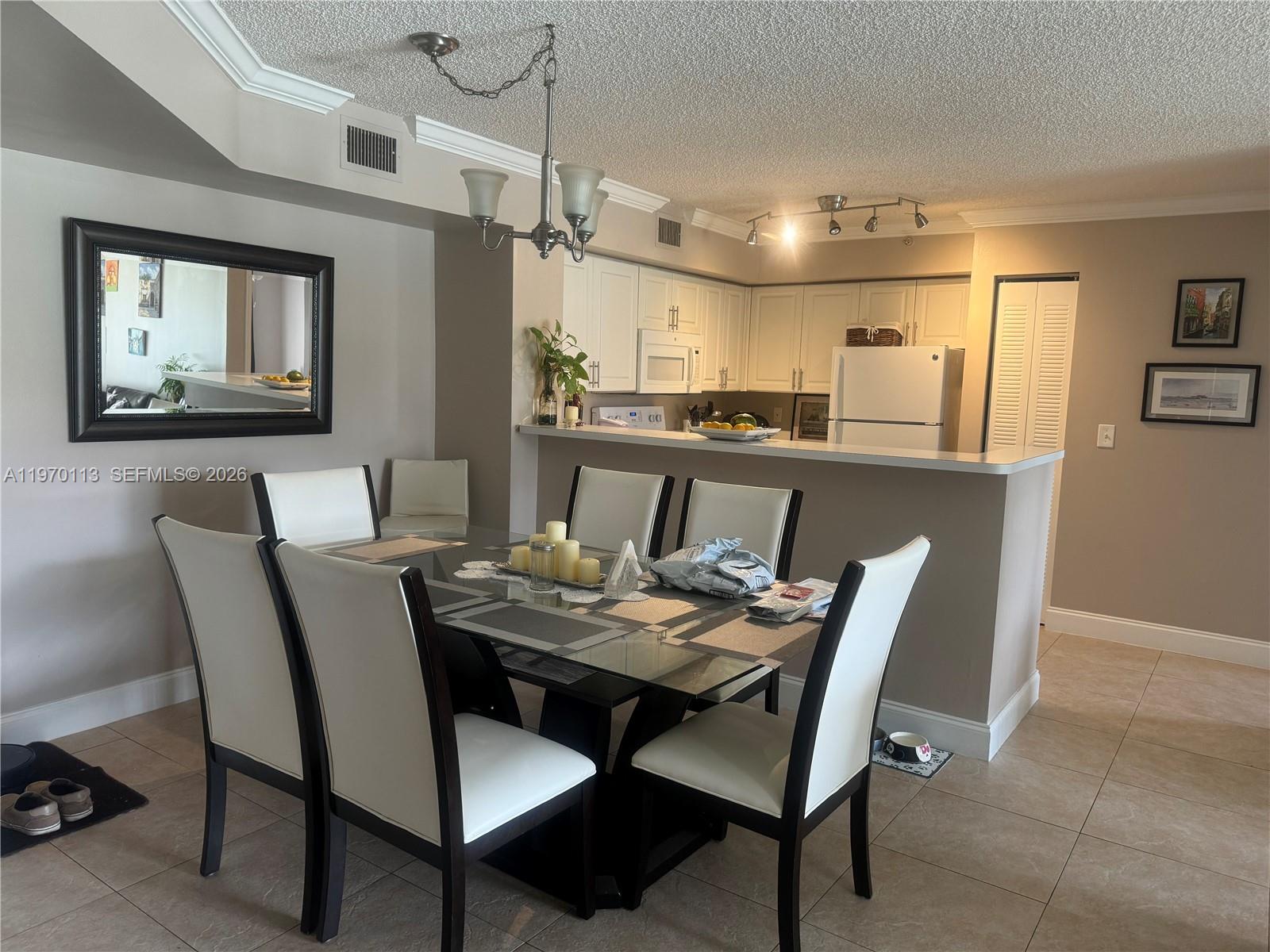 2091 Renaissance Boulevard, Unit 104 Miramar, FL 33025 - Photo 10 of 31 a view of a dining room with furniture