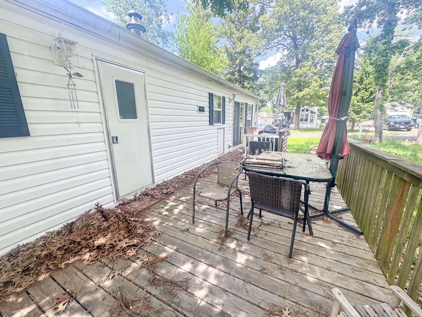 7-98 Woodhaven Sublette, IL 61367 - Photo 4 of 23 a view of a chairs and table on the wooden deck