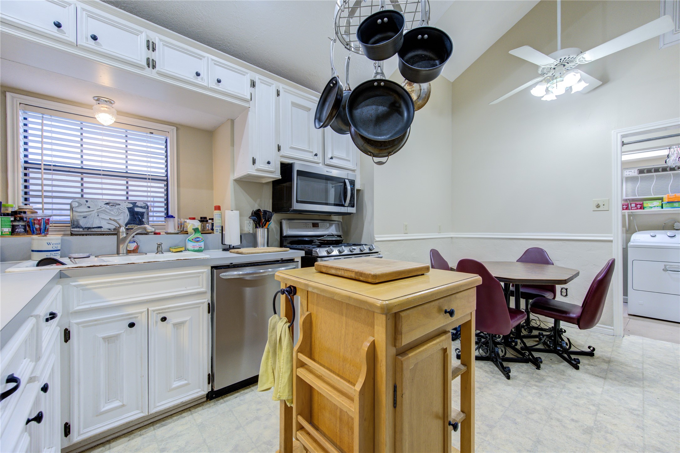 11217 Todd Street Houston, TX 77055 - Photo 11 of 49 a kitchen with a cabinets a sink and a clock on the wall