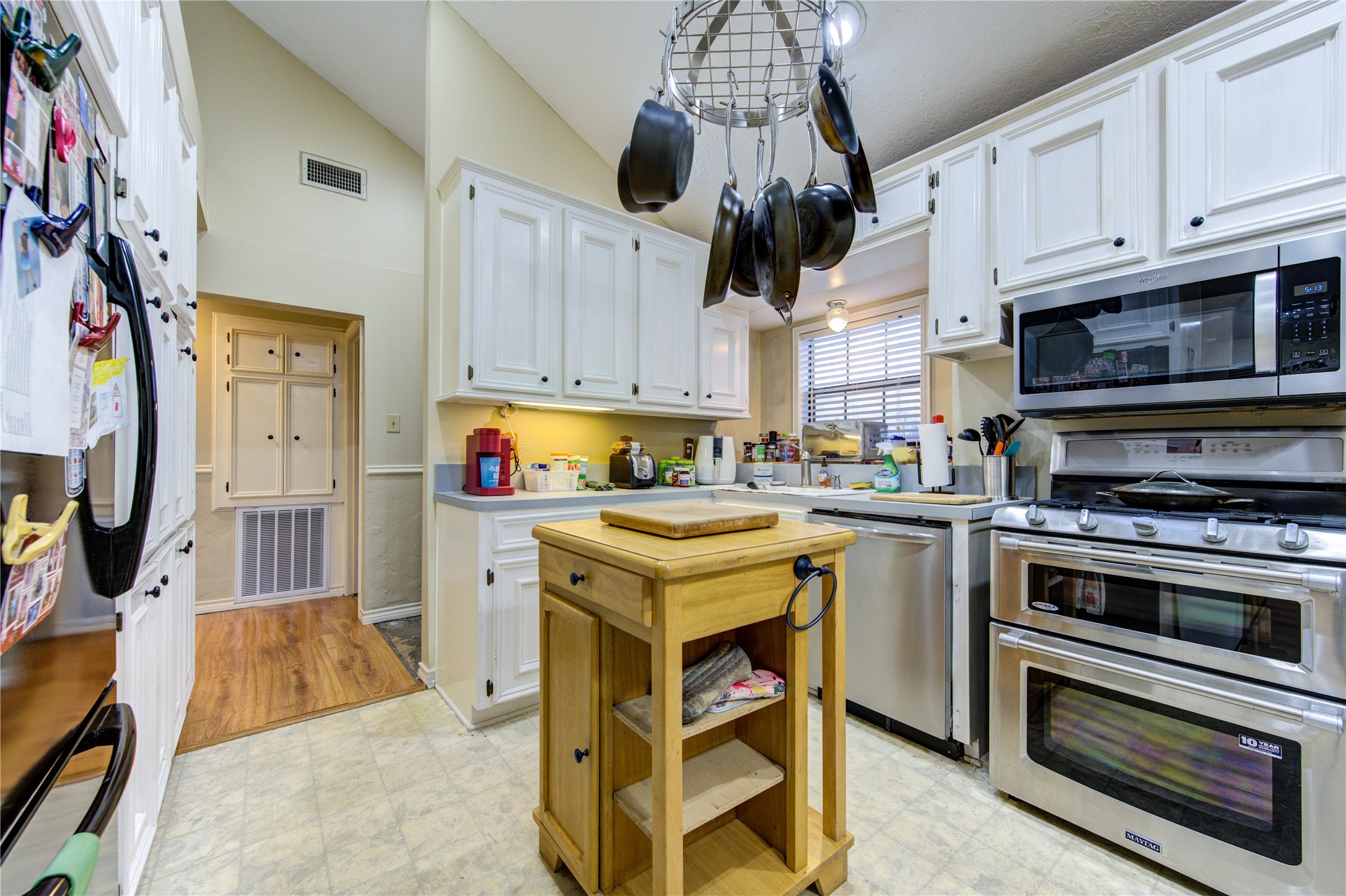 11217 Todd Street Houston, TX 77055 - Photo 15 of 49 a kitchen with stainless steel appliances granite countertop a stove sink microwave and cabinets