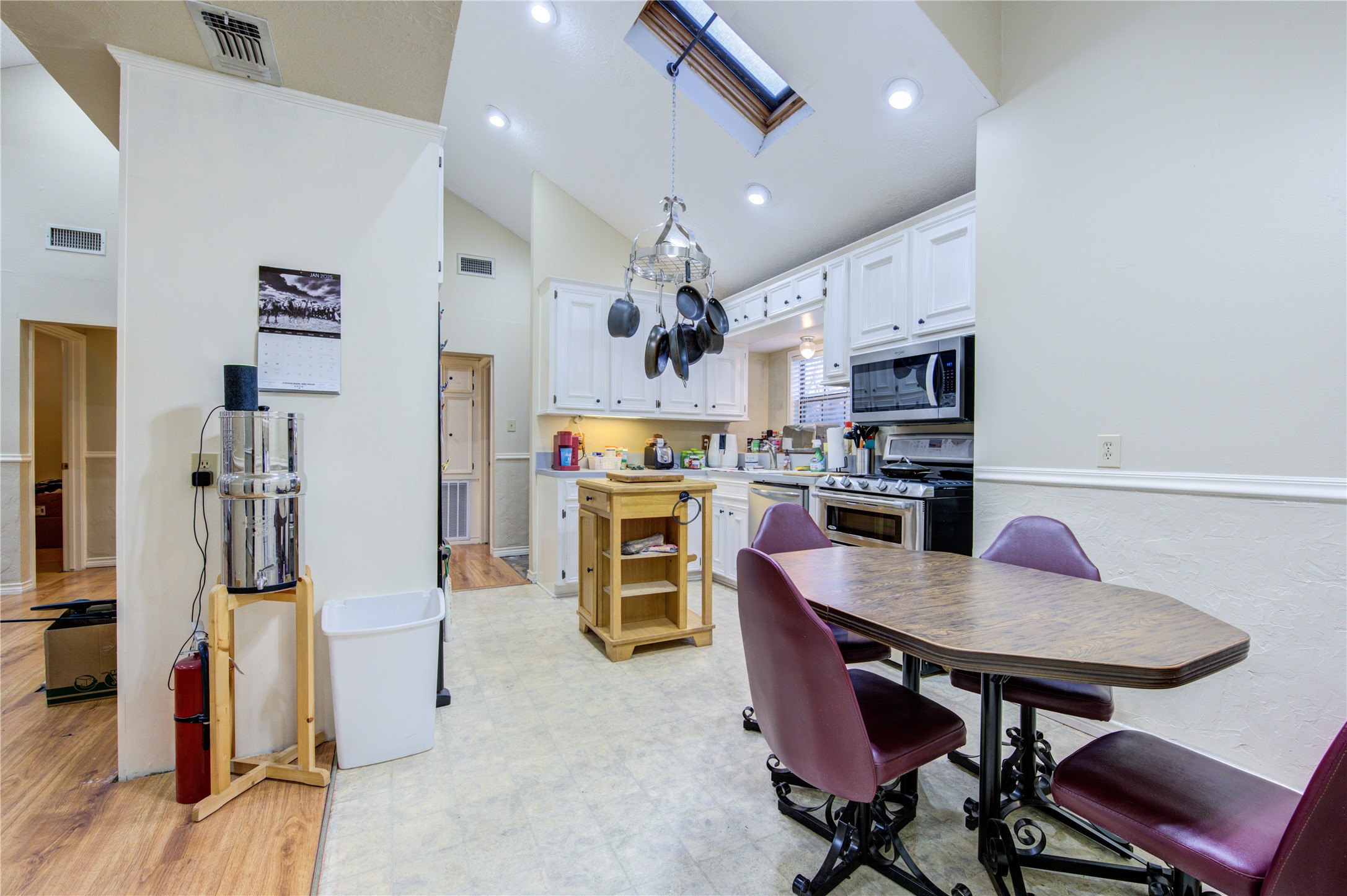 11217 Todd Street Houston, TX 77055 - Photo 19 of 49 a kitchen with stainless steel appliances kitchen island dining table and chairs
