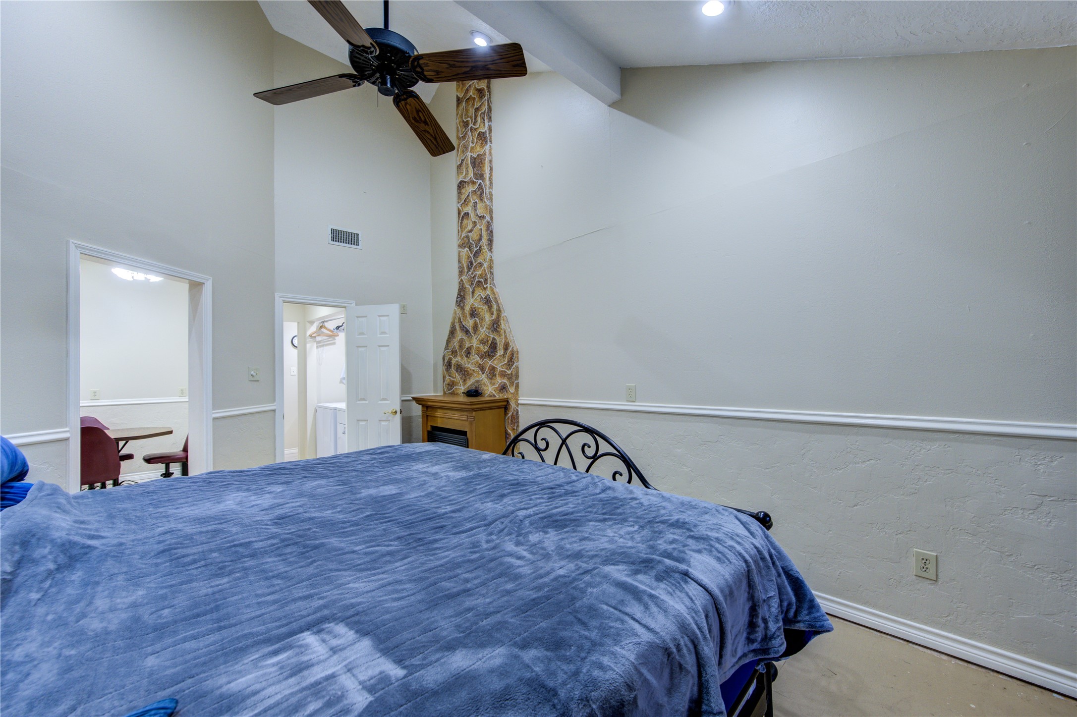 11217 Todd Street Houston, TX 77055 - Photo 27 of 49 a bedroom with a bed and a chandelier