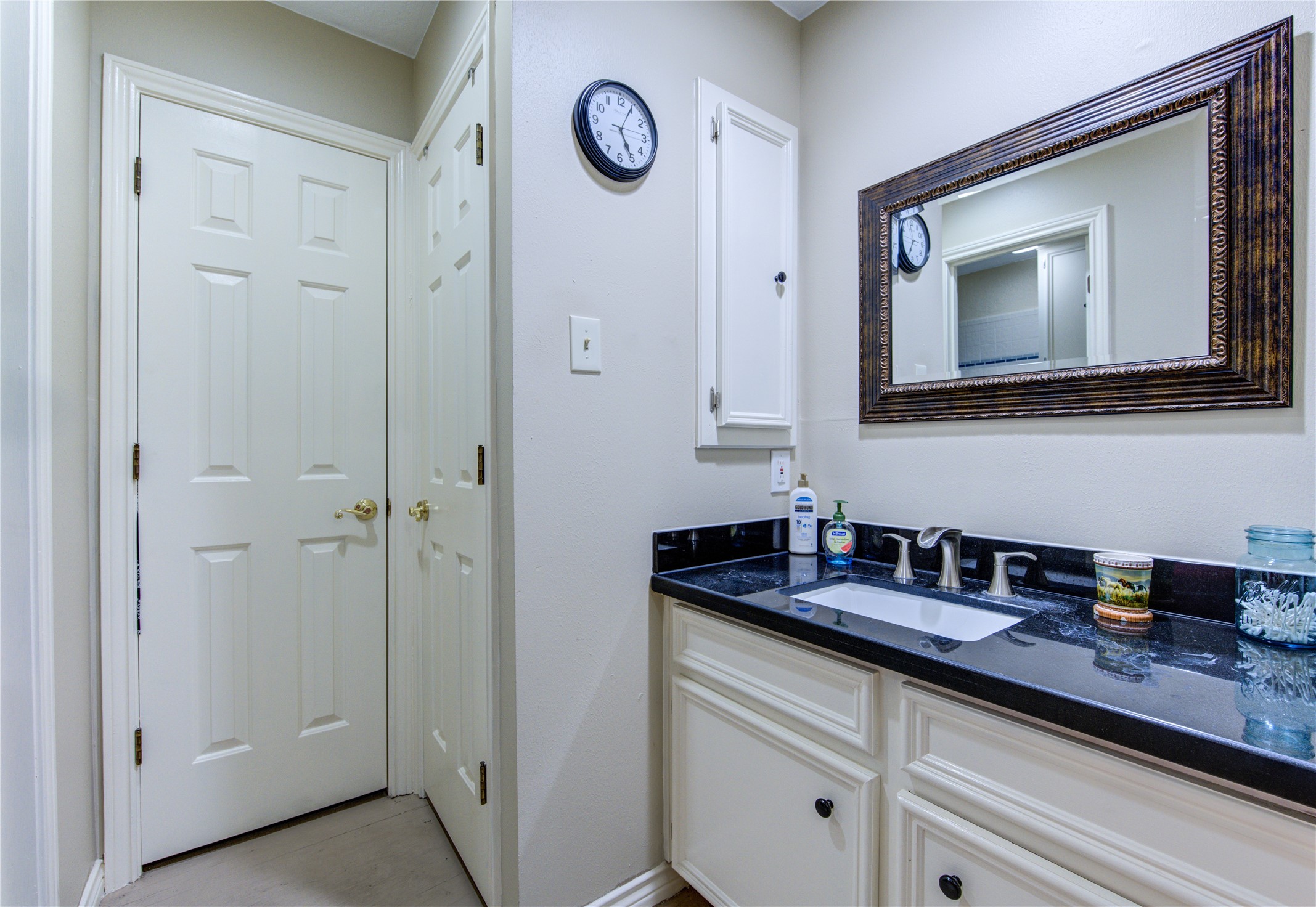 11217 Todd Street Houston, TX 77055 - Photo 32 of 49 a bathroom with a granite countertop sink and a mirror