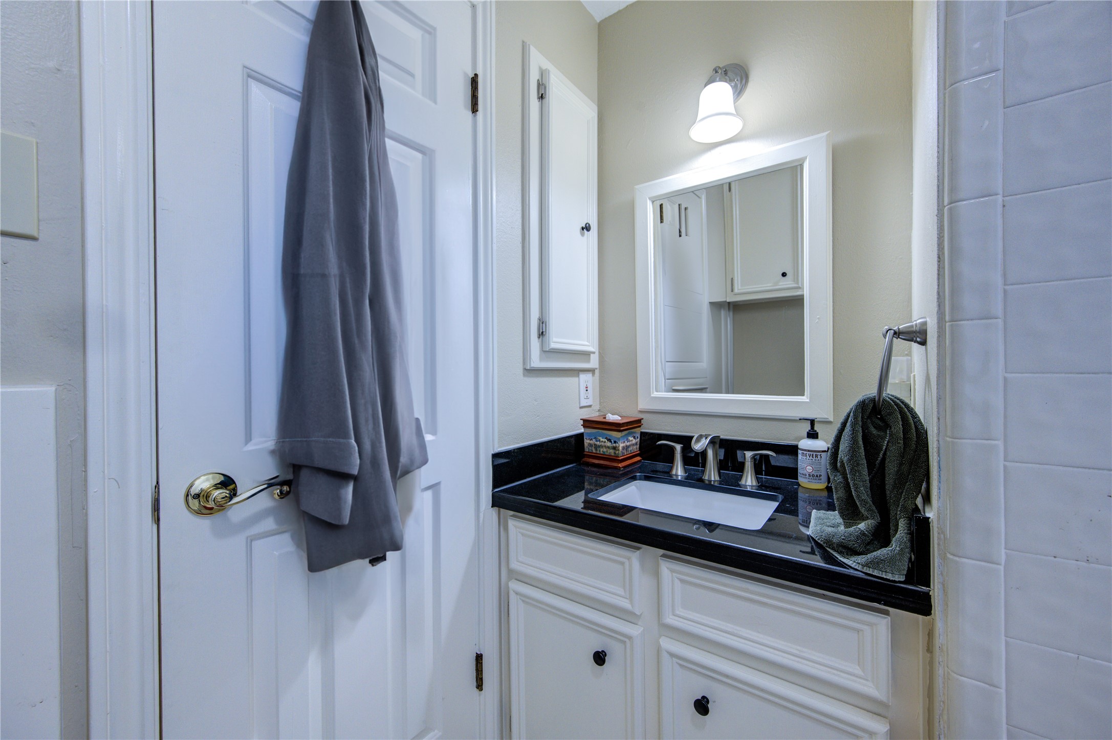 11217 Todd Street Houston, TX 77055 - Photo 33 of 49 a bathroom with a granite countertop sink and a mirror