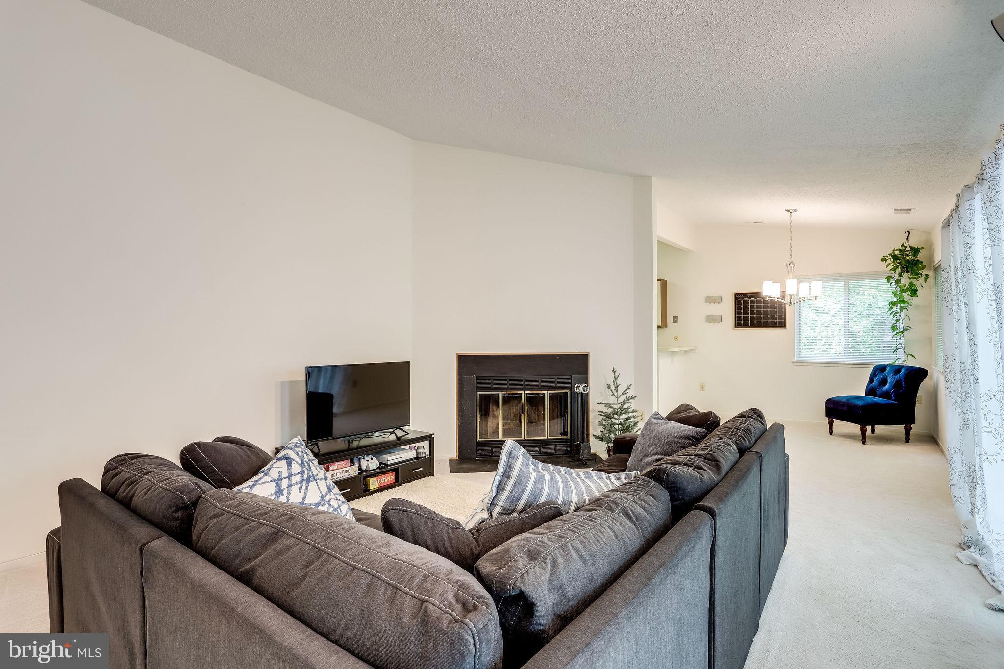 11027 Villaridge Court Reston, VA 20191 - Photo 8 of 28 a living room with furniture and a flat screen tv